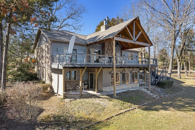 rear view of house with a deck and a patio area