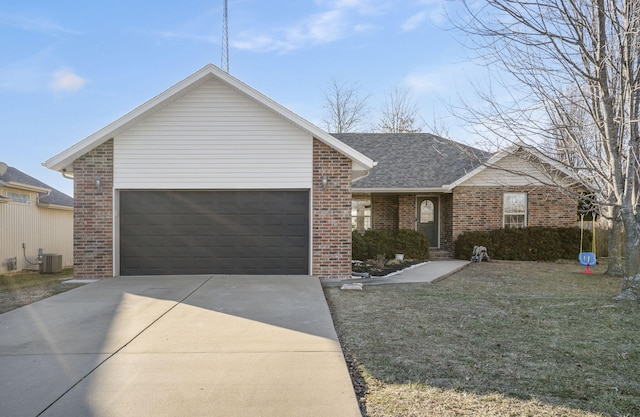 ranch-style home featuring a garage, central AC, and a front yard