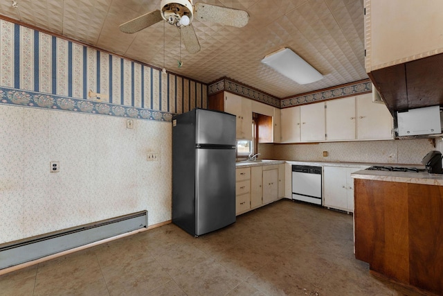 kitchen featuring stainless steel refrigerator, a baseboard heating unit, dishwasher, stove, and white cabinets