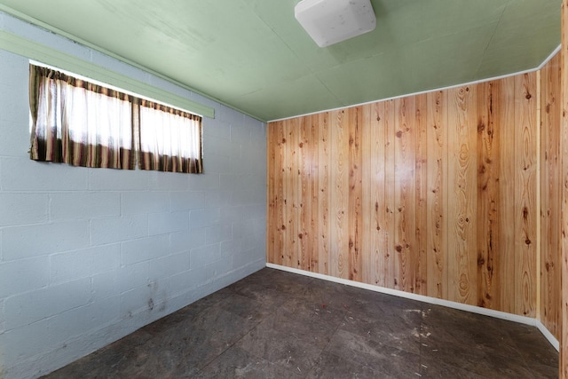 unfurnished room with wood walls