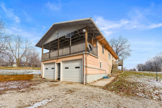 exterior space with a balcony and a garage