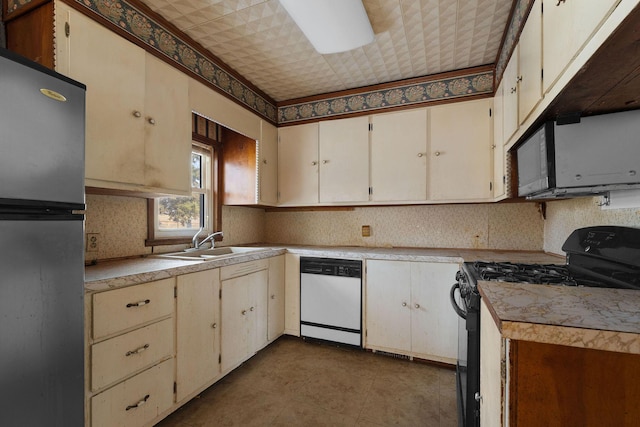 kitchen with cream cabinetry, light tile patterned floors, sink, and black appliances