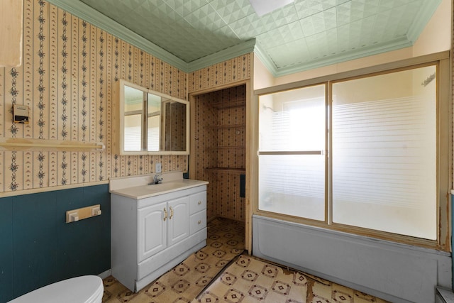 full bathroom featuring crown molding, vanity, toilet, and combined bath / shower with glass door