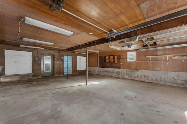 garage featuring a garage door opener and wooden ceiling