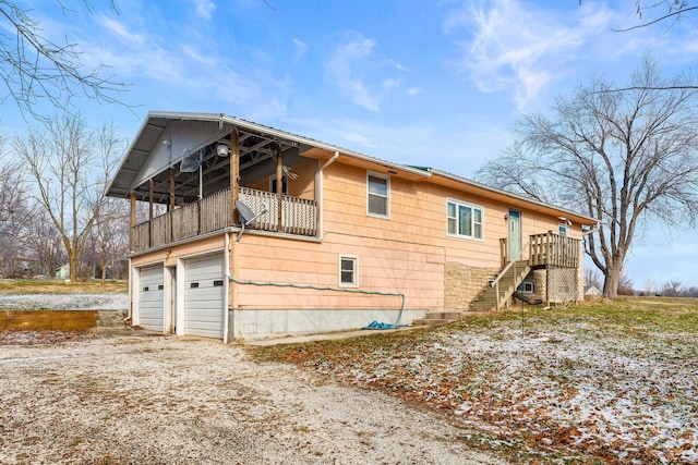 view of home's exterior featuring a balcony and a garage