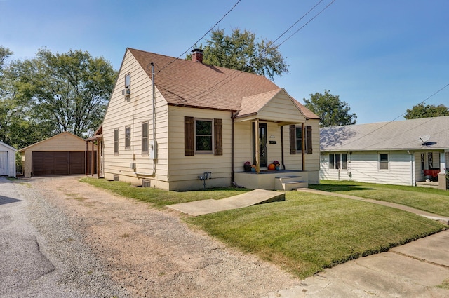 bungalow-style home with a garage, an outbuilding, and a front lawn