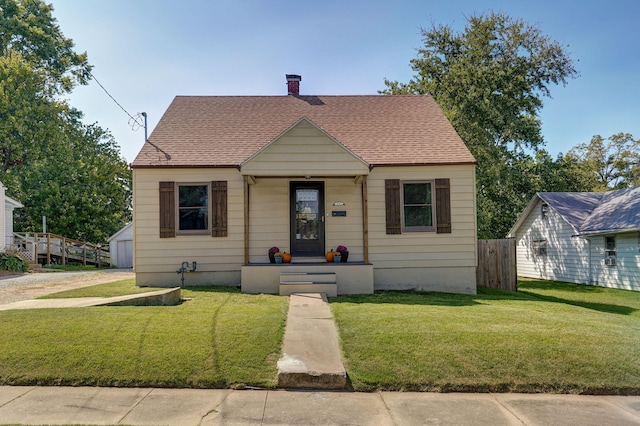 bungalow-style home featuring a front yard