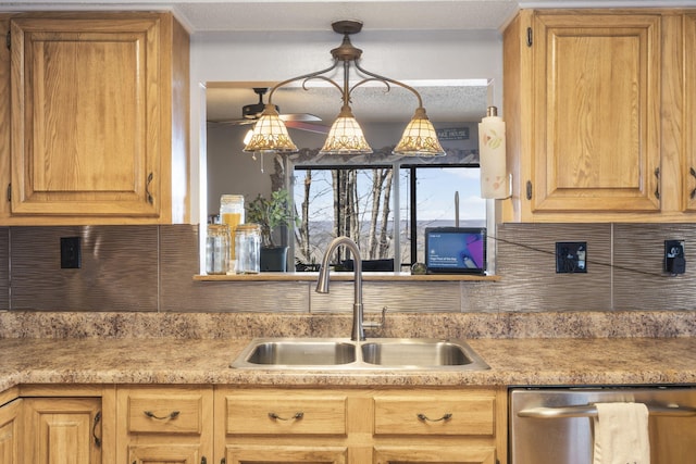 kitchen with tasteful backsplash, sink, hanging light fixtures, stainless steel dishwasher, and ceiling fan