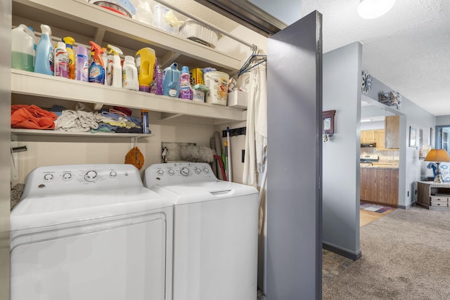 clothes washing area featuring washer and dryer, carpet, and a textured ceiling