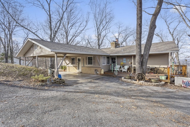 ranch-style home featuring a carport