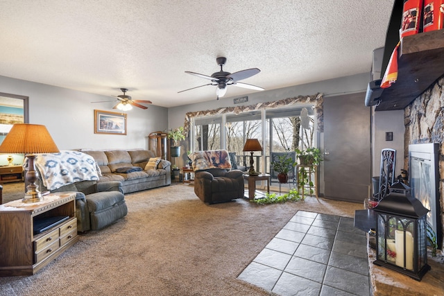 carpeted living room featuring ceiling fan and a textured ceiling