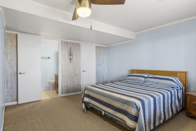 carpeted bedroom featuring ensuite bathroom, ornamental molding, and ceiling fan