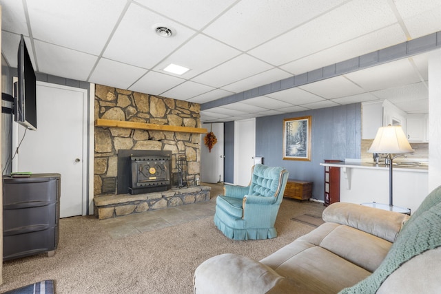 living room featuring carpet flooring and a paneled ceiling