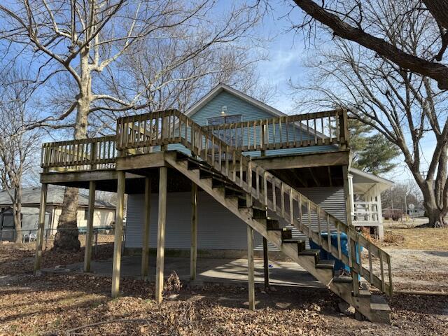 back of property with a wooden deck