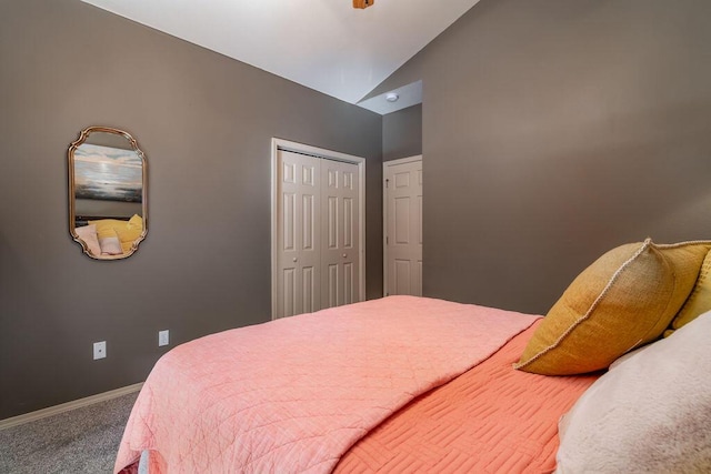 bedroom with carpet flooring, vaulted ceiling, and a closet