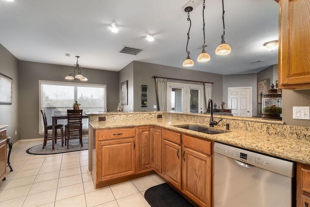 kitchen featuring decorative light fixtures, sink, stainless steel dishwasher, kitchen peninsula, and light stone countertops