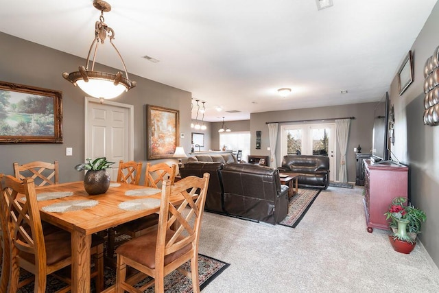 dining room featuring light colored carpet