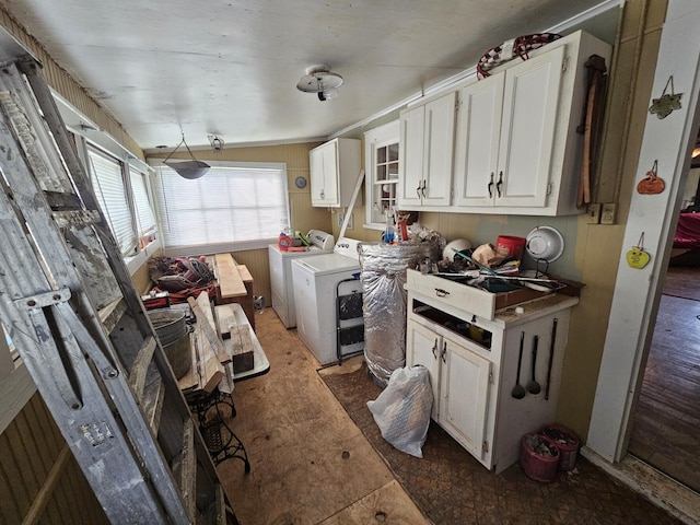 kitchen with separate washer and dryer, sink, and white cabinets