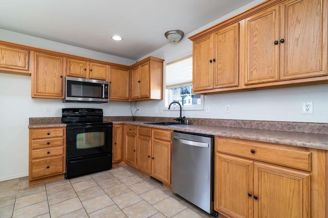 kitchen with sink, light tile patterned floors, and stainless steel appliances