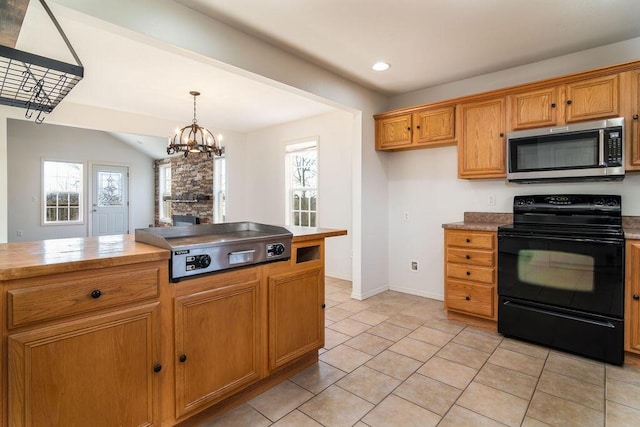 kitchen with vaulted ceiling, decorative light fixtures, black electric range oven, light tile patterned floors, and a notable chandelier