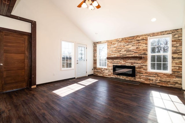 unfurnished living room featuring dark hardwood / wood-style flooring, a fireplace, high vaulted ceiling, and ceiling fan