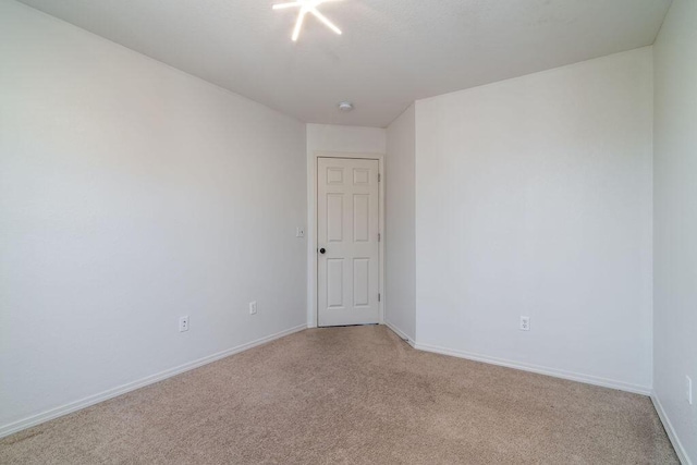 spare room with light carpet