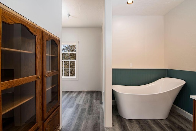 bathroom featuring hardwood / wood-style floors and a bath