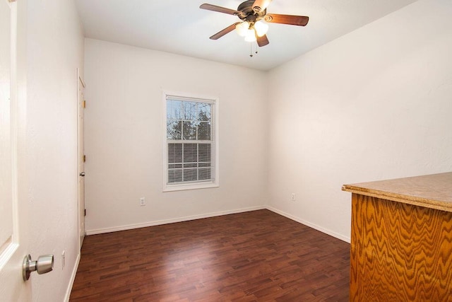 empty room featuring ceiling fan and dark hardwood / wood-style floors