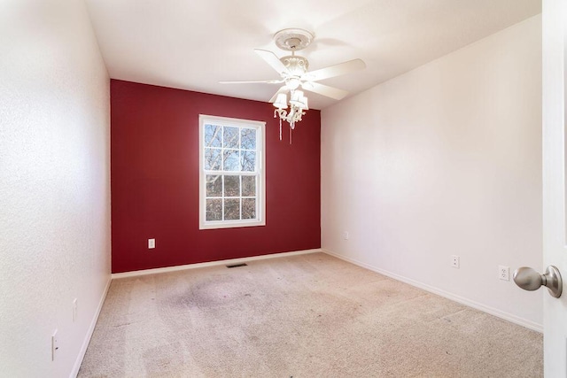 empty room featuring light carpet and ceiling fan