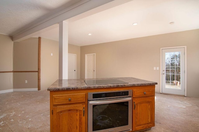 kitchen featuring black electric cooktop and oven