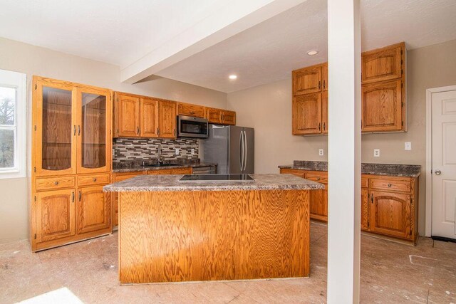 kitchen with sink, stainless steel appliances, a center island, and beamed ceiling