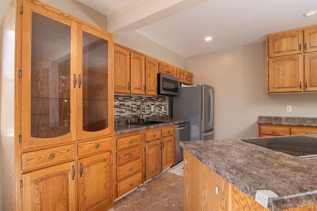 kitchen with tasteful backsplash, appliances with stainless steel finishes, and sink