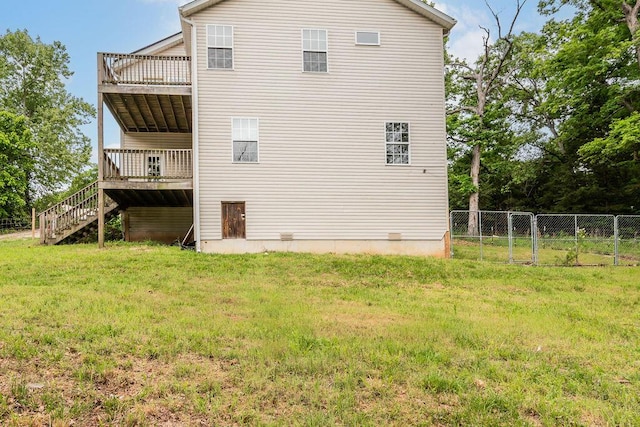 rear view of property with stairway and a deck