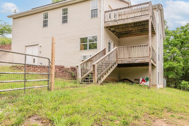 back of property with stairs, a deck, and fence