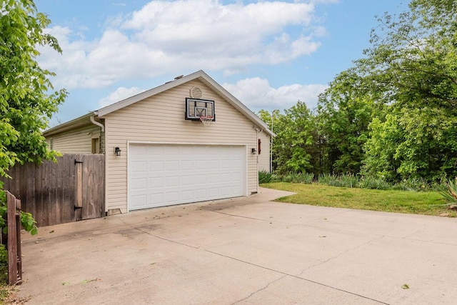 detached garage featuring fence