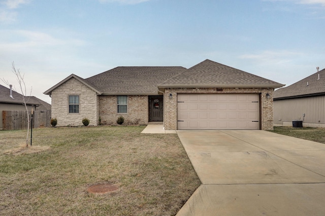 single story home featuring a garage, central AC unit, and a front lawn