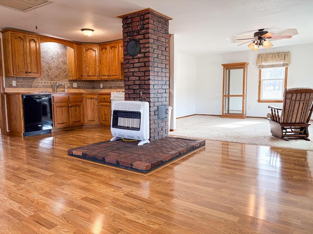 kitchen featuring heating unit, dishwasher, ceiling fan, light hardwood / wood-style floors, and decorative backsplash