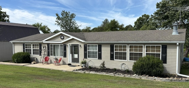 view of front facade with a patio area and a front lawn