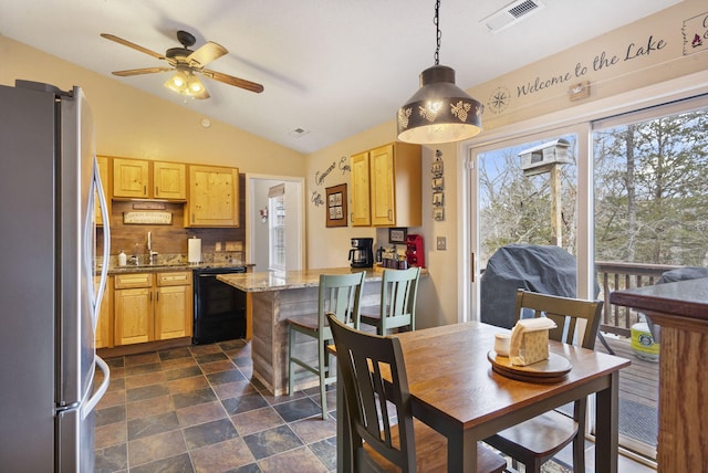 dining room featuring vaulted ceiling, ceiling fan, visible vents, and stone finish flooring