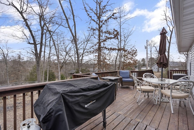 wooden terrace featuring a grill