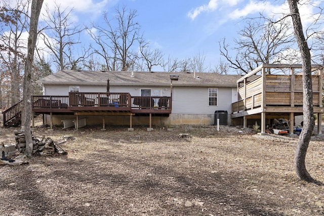 rear view of property featuring a wooden deck and central air condition unit