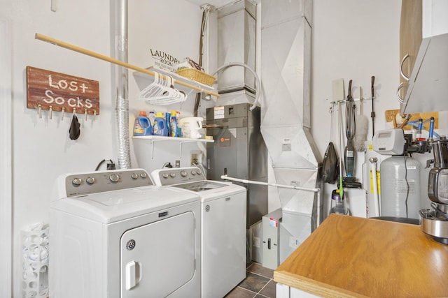 laundry room with dark tile patterned flooring, laundry area, and washer and clothes dryer