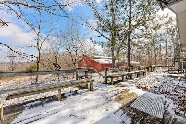 snow covered deck with an outbuilding