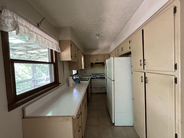 406 Red Bridge Rd, Ozark, MO 65721 - kitchen with white appliances, light countertops, under cabinet range hood, tile patterned floors, and a textured ceiling