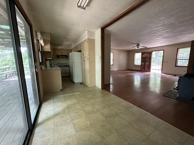 406 Red Bridge Rd, Ozark, MO 65721 - kitchen with freestanding refrigerator, range, plenty of natural light, a textured ceiling, and light countertops