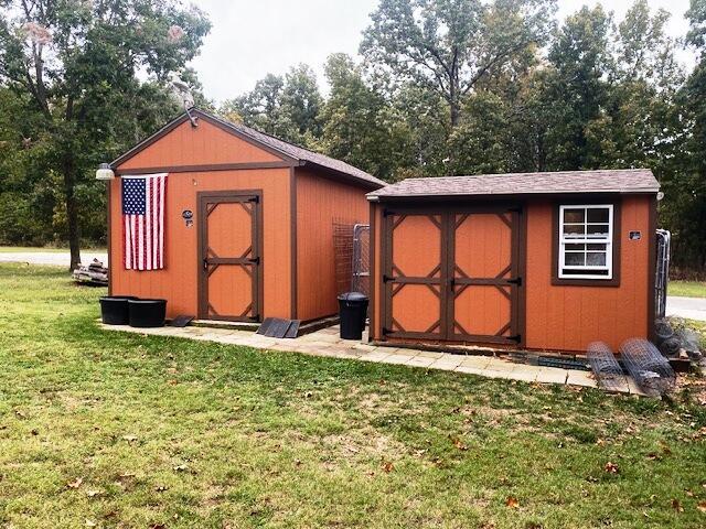 view of outbuilding featuring a lawn