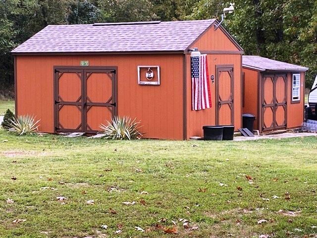 view of outbuilding with a yard