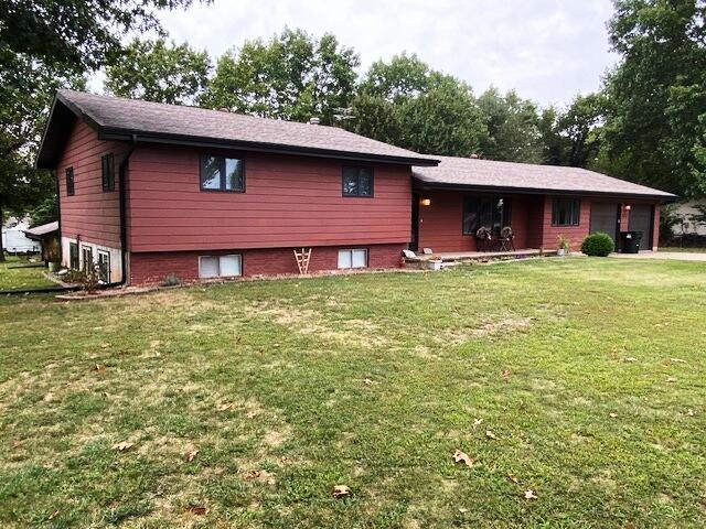 tri-level home with a front lawn