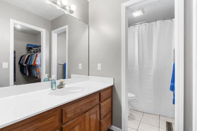 bathroom with vanity, tile patterned floors, toilet, and a shower with shower curtain