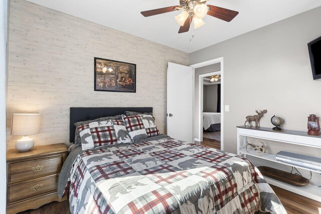 bedroom with dark wood-type flooring and ceiling fan